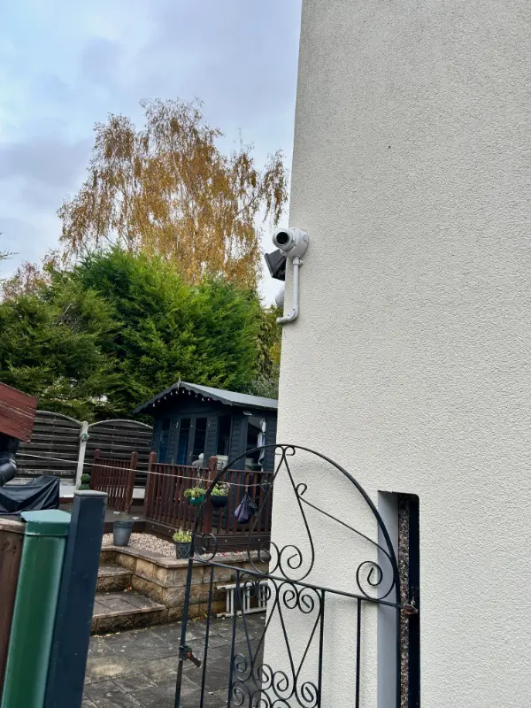 Weatherproof junction box protecting CCTV cable connections on an external wall