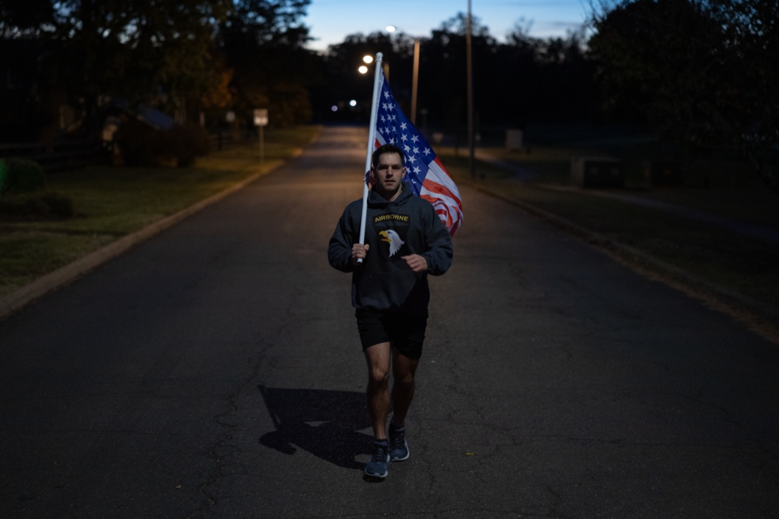 Flag runner on a quiet road at dawn