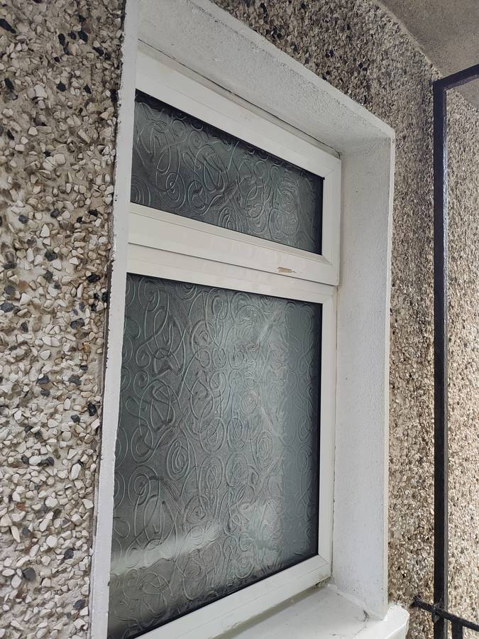 Window before cleaning, heavy grime buildup