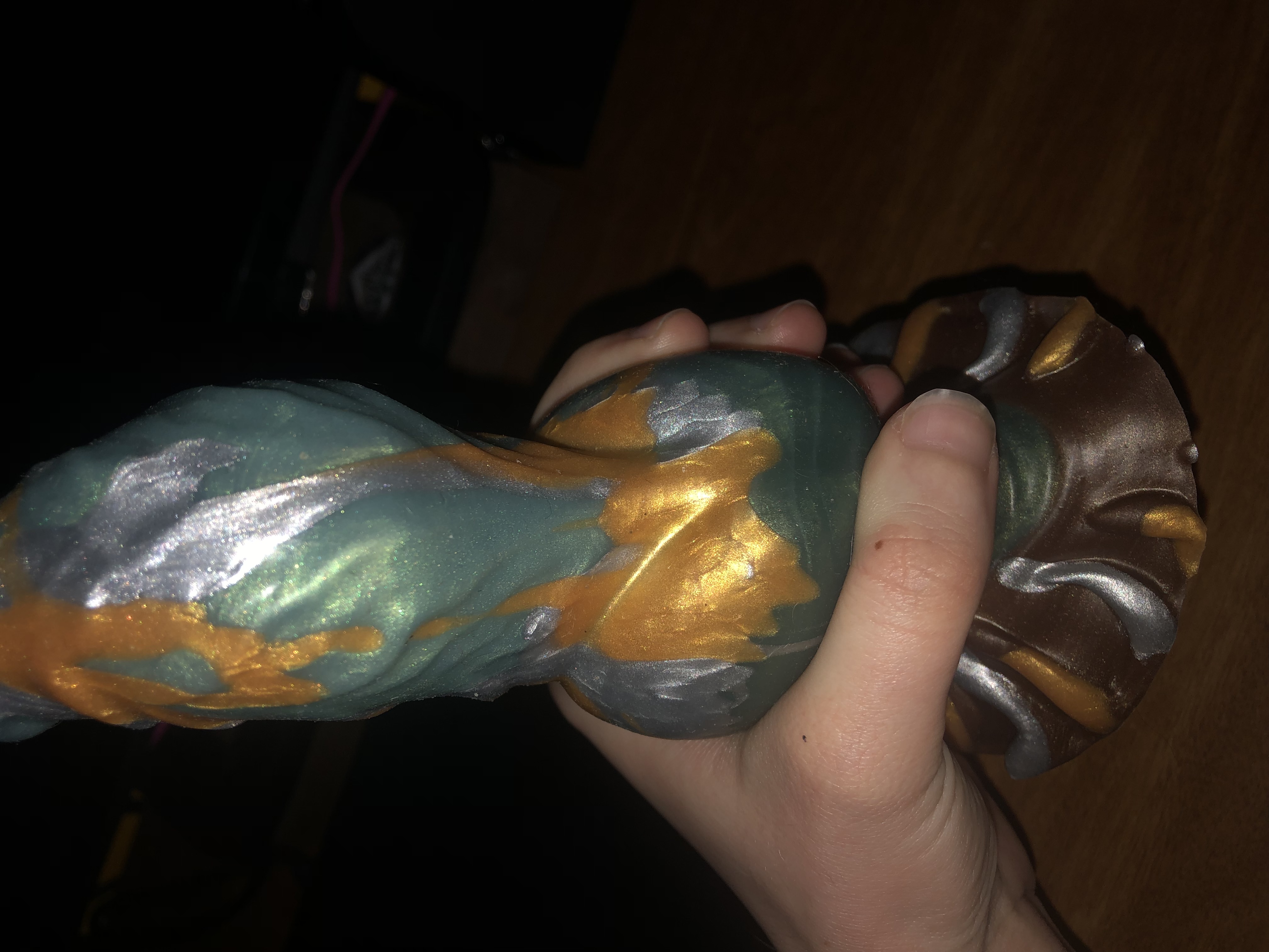 me holding ossium by the knot, showing my hand can't even fully close around it