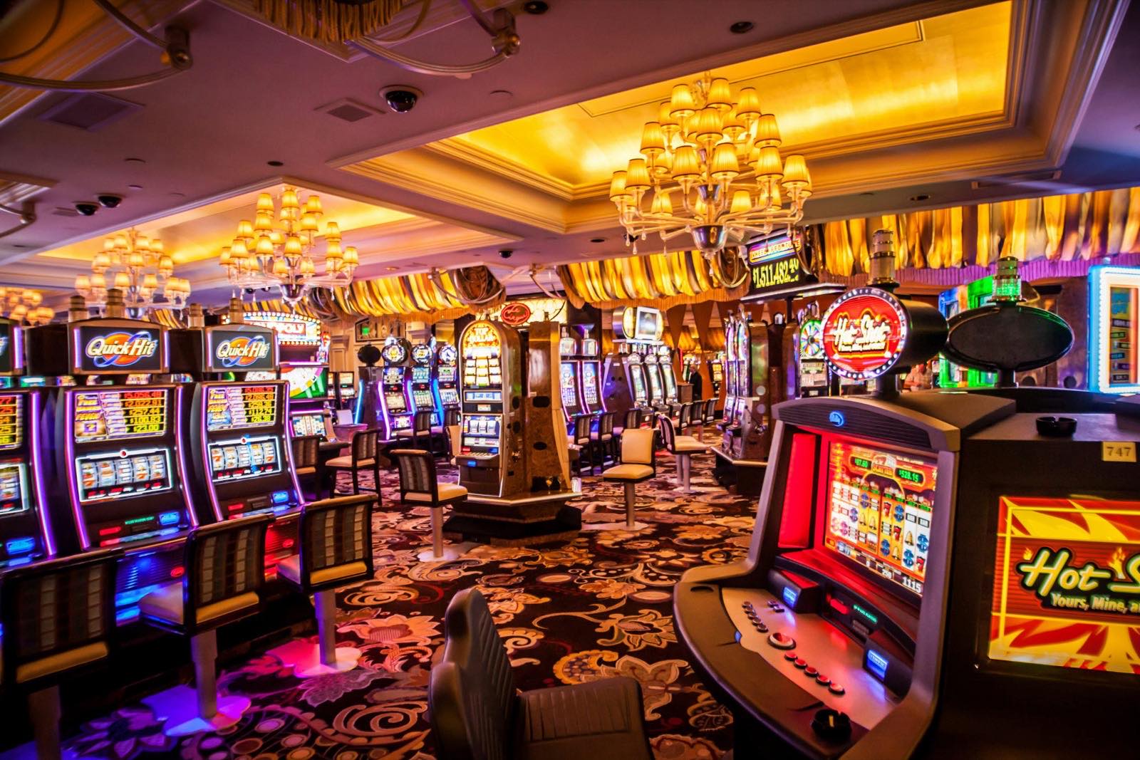 Casino floor under warm chandeliers