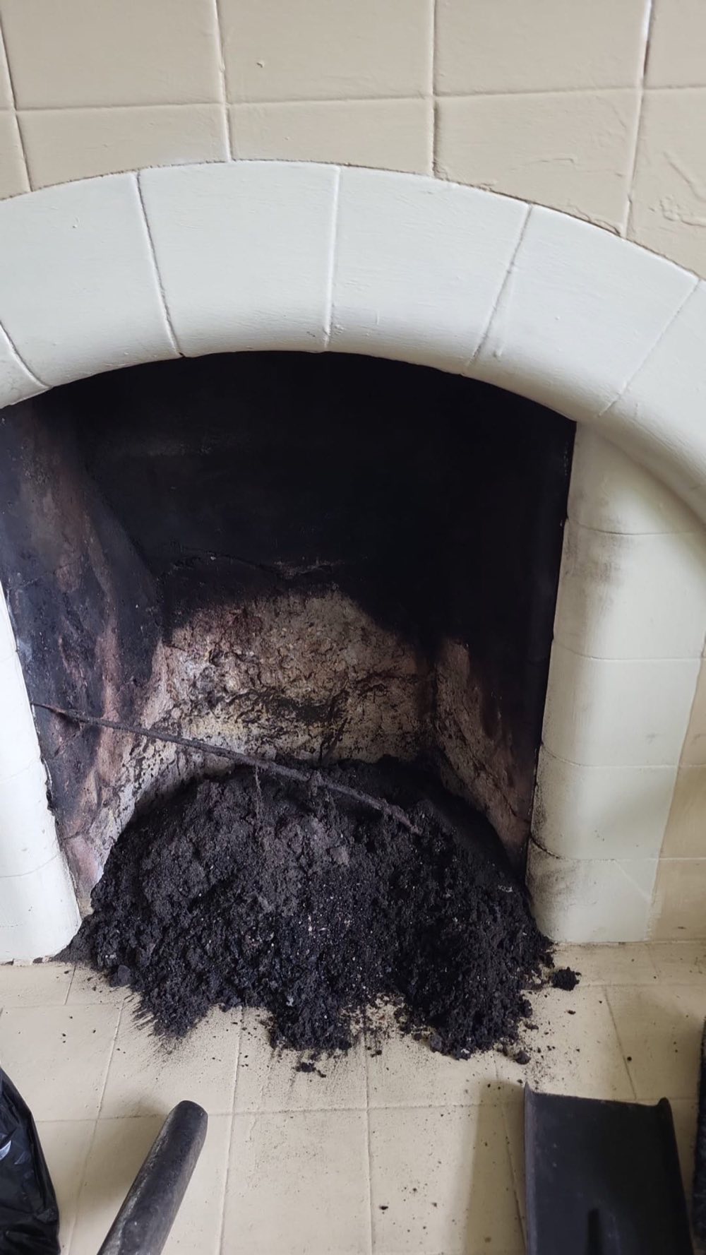 Soot cleared from a tiled-arch fireplace
