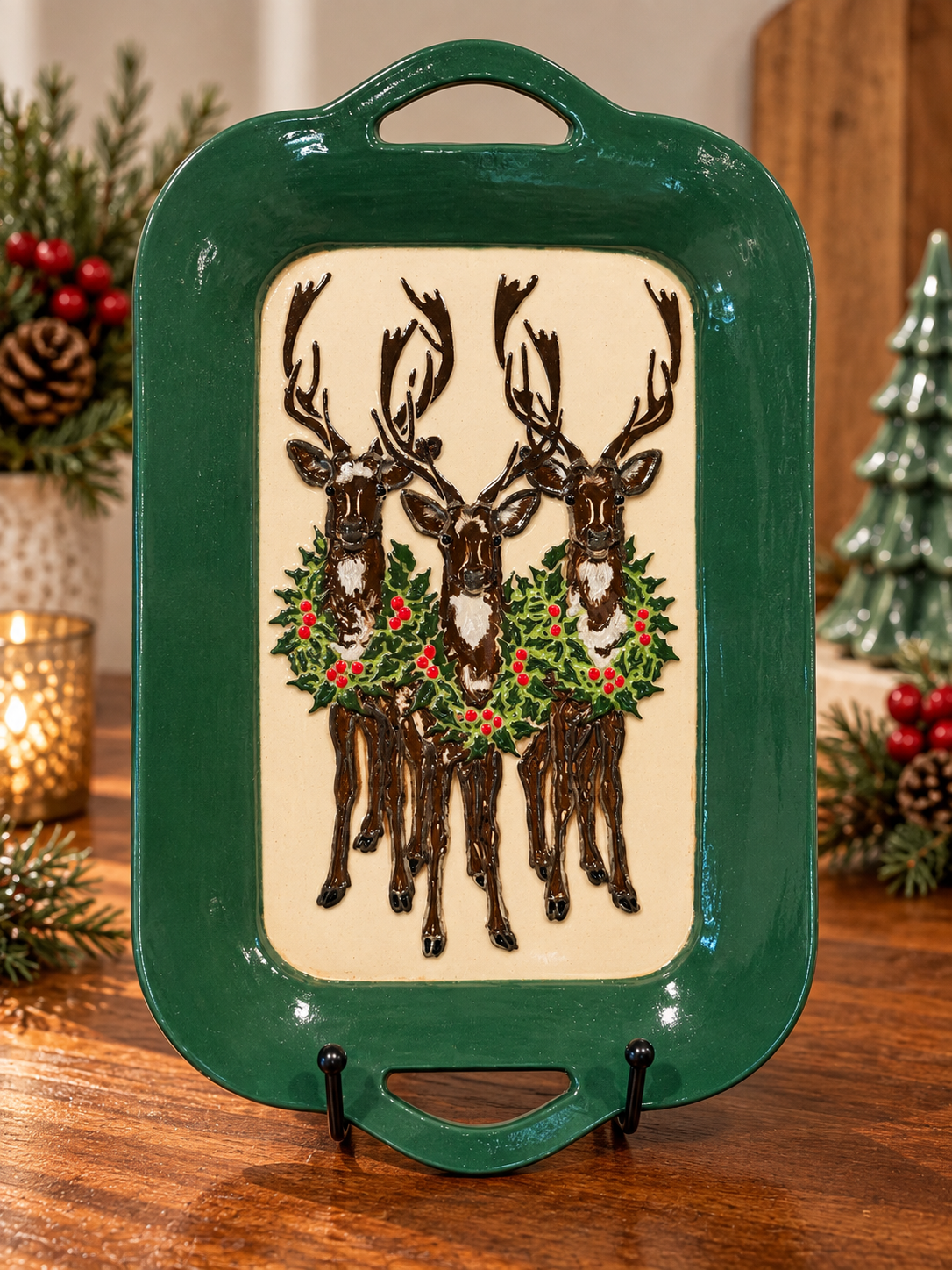 Rectangular hand-built tray with a glossy dark green border and a cream center with hand-painted reindeer and holly
