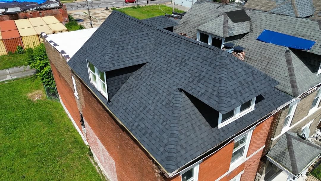 Side aerial view of completed shingle roof