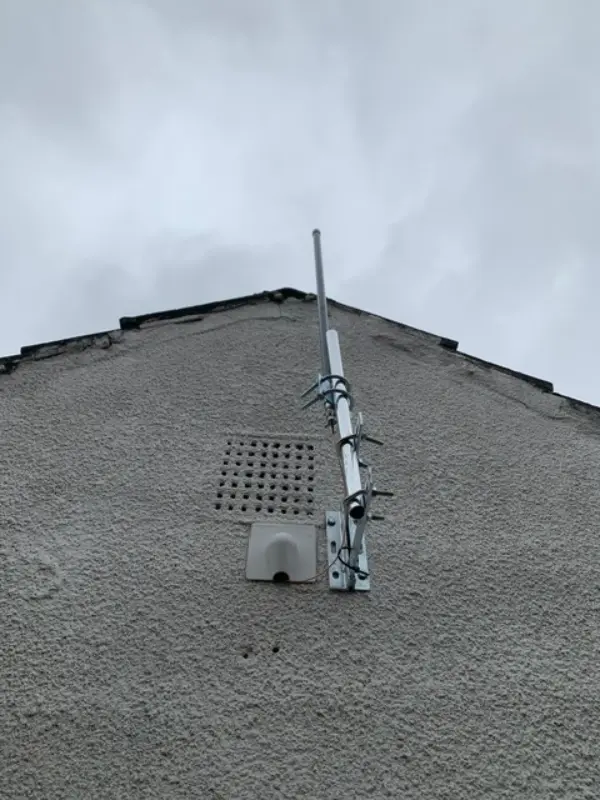 Wireless security camera setup with solar panel on a UK garden shed