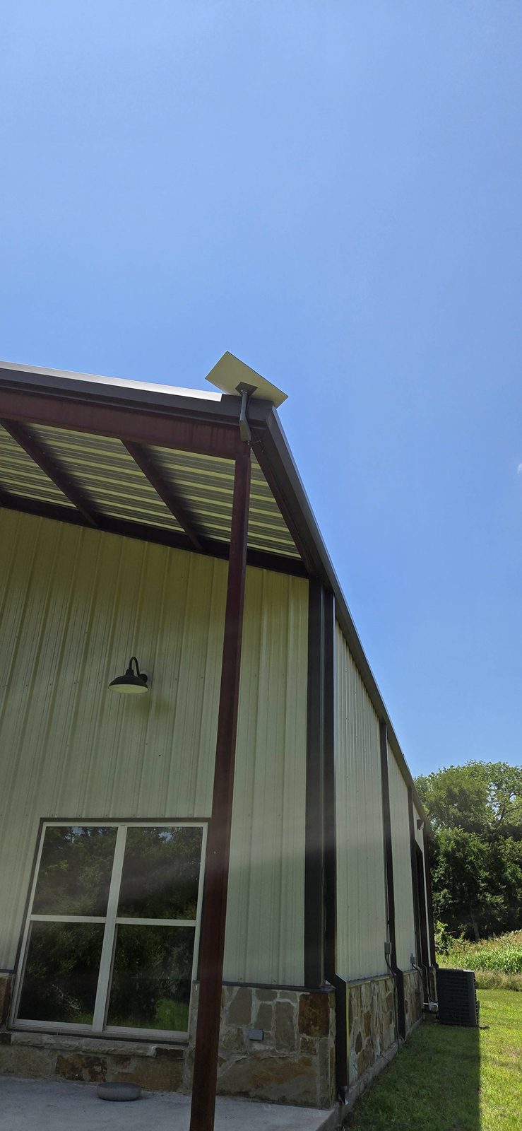 Starlink dish eave-mounted on a metal building